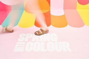 Close-up image of a reboard display of the phrase 'Into Spring Colour'.