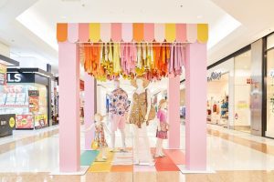 A retail display of spring clothes in a mall. 