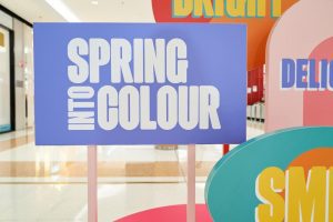 Close-up image of a reboard display of the phrase 'Into Spring Colour'.